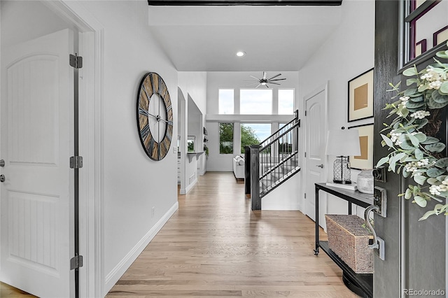 entryway featuring light wood-type flooring, a ceiling fan, baseboards, recessed lighting, and stairway
