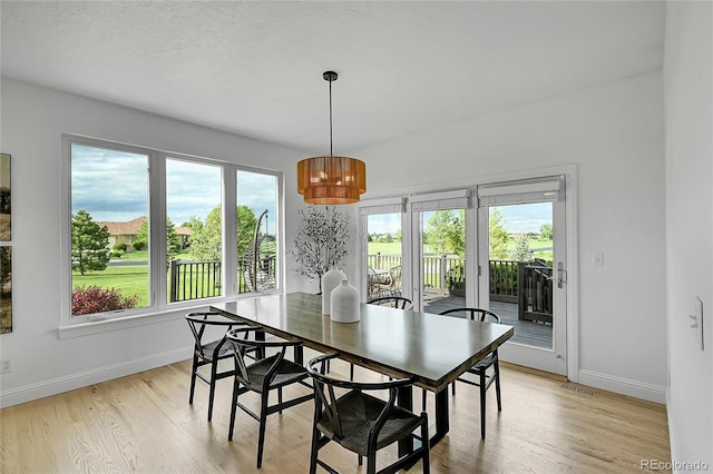 dining area featuring baseboards, light wood-style flooring, and plenty of natural light