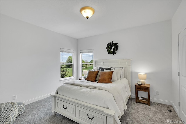 bedroom with light colored carpet and baseboards