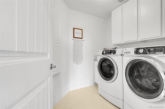 laundry room with washer and dryer, cabinet space, and baseboards