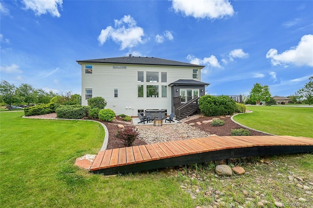 back of property with a yard, a deck, a patio, and stairs