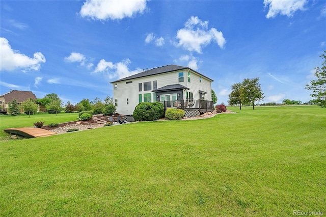 back of property with a deck and a lawn