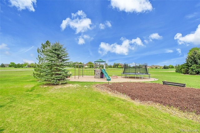 community play area featuring a lawn and a trampoline