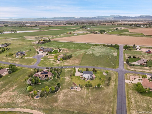 aerial view of property and surrounding area with a mountain backdrop and rural landscape
