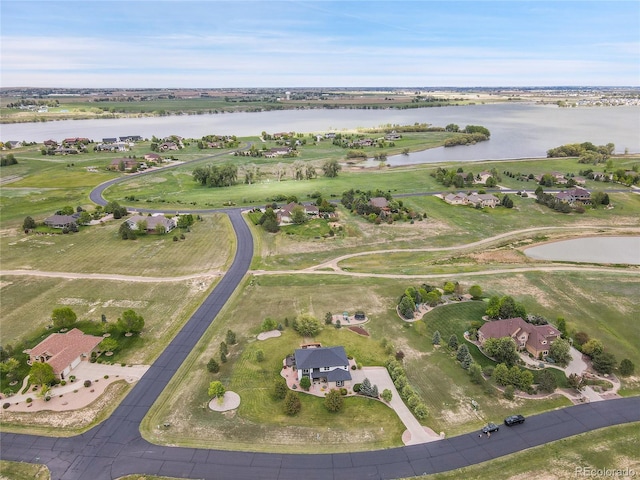 aerial view of property and surrounding area featuring a nearby body of water