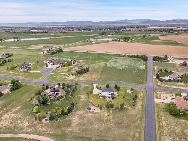 aerial view of property's location featuring a mountain backdrop and rural landscape
