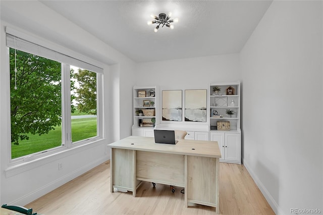 office space with light wood finished floors and baseboards