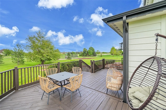 37028 Soaring Eagle Cir, Severance, CO 80550 - wooden deck featuring outdoor dining space, a yard, and view of golf course