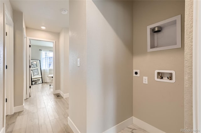 washroom with hookup for an electric dryer, hookup for a washing machine, and light hardwood / wood-style floors