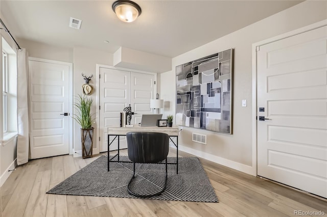 office area with light hardwood / wood-style flooring