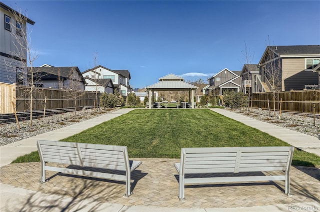 view of property's community featuring a gazebo, a patio area, and a yard