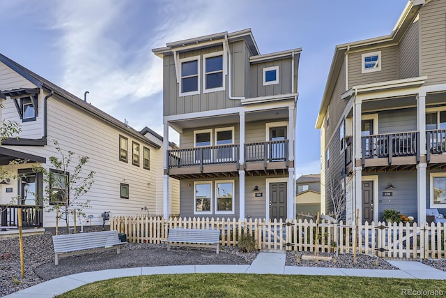 128 E Douglas St, Superior, CO 80027 - rear view of house featuring board and batten siding and a fenced front yard
