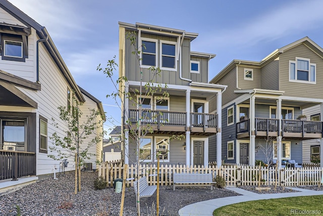 view of front of house featuring central AC and a balcony