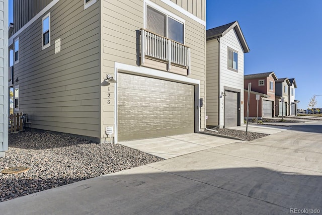 128 E Douglas St, Superior, CO 80027 - view of side of property with an attached garage, driveway, and board and batten siding