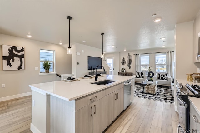 128 E Douglas St, Superior, CO 80027 - kitchen featuring a sink, range, light wood-style floors, stainless steel dishwasher, and light countertops
