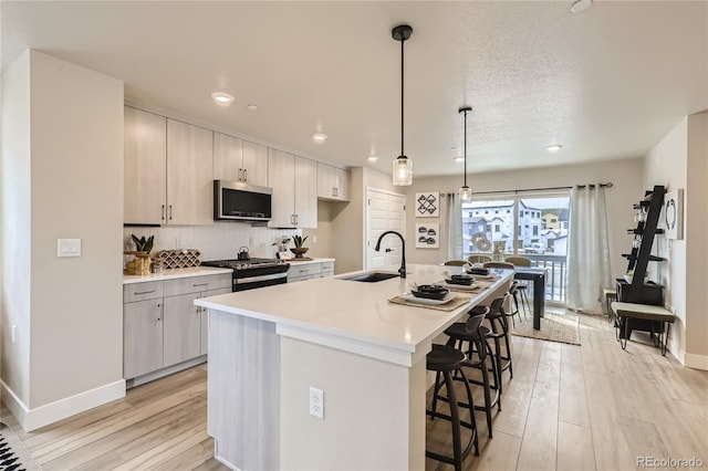 128 E Douglas St, Superior, CO 80027 - kitchen featuring appliances with stainless steel finishes, a sink, light wood-style floors, light countertops, and recessed lighting