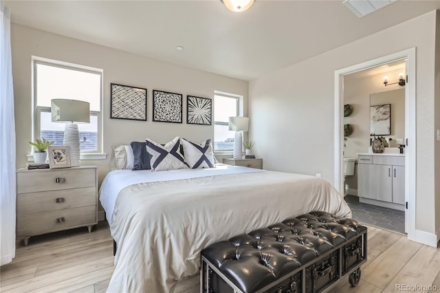 128 E Douglas St, Superior, CO 80027 - bedroom with light wood finished floors, multiple windows, and connected bathroom