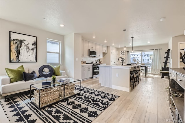 128 E Douglas St, Superior, CO 80027 - living room featuring light wood-type flooring, recessed lighting, and a textured ceiling