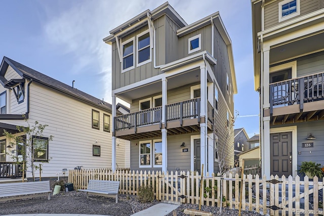 128 E Douglas St, Superior, CO 80027 - view of property with a balcony, board and batten siding, and a fenced front yard