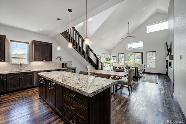 701 Saddle Ridge Cir, Granby, CO 80446 - kitchen featuring a sink, healthy amount of natural light, dark brown cabinets, dark wood-style flooring, and high vaulted ceiling