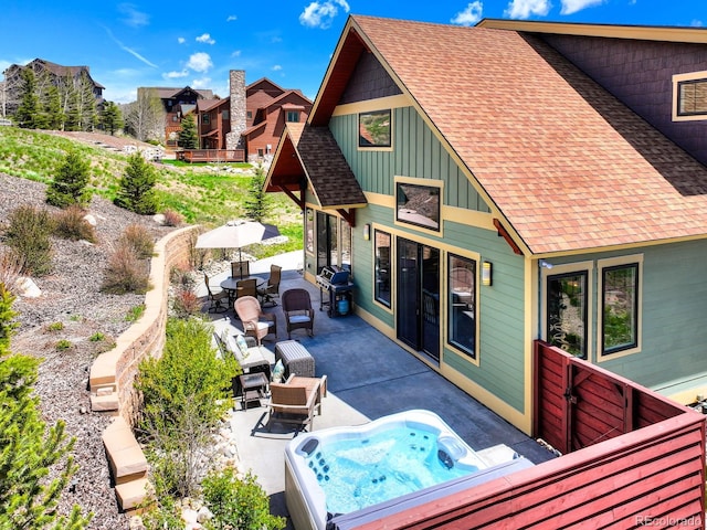 701 Saddle Ridge Cir, Granby, CO 80446 - view of patio with an outdoor hot tub, grilling area, and outdoor dining area