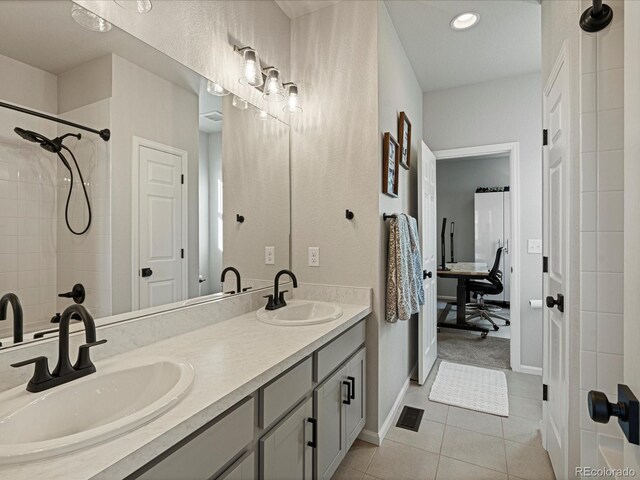 27110 E Fremont Pl, Aurora, CO 80016 - bathroom with tile patterned floors, double vanity, a tile shower, baseboards, and recessed lighting