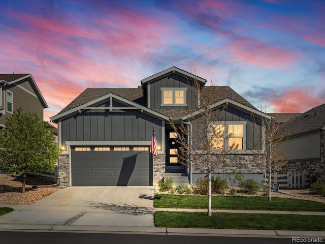 27110 E Fremont Pl, Aurora, CO 80016 - craftsman inspired home with board and batten siding, driveway, an attached garage, a shingled roof, and stone siding