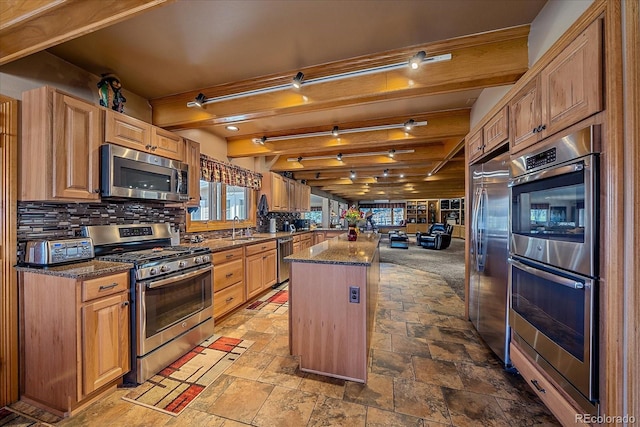 kitchen featuring beamed ceiling, tile floors, backsplash, appliances with stainless steel finishes, and sink