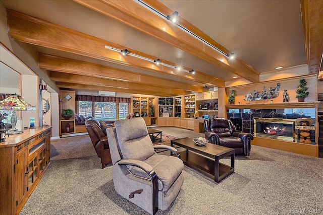 carpeted living room with built in features, beam ceiling, track lighting, a premium fireplace, and a wall mounted AC