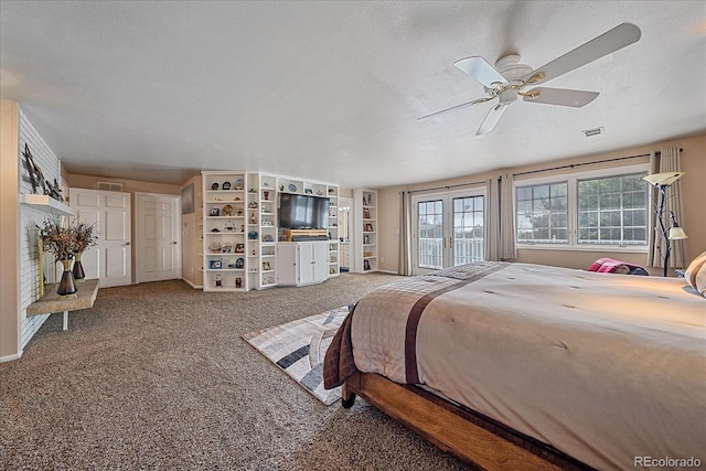 bedroom featuring a textured ceiling, carpet floors, and ceiling fan