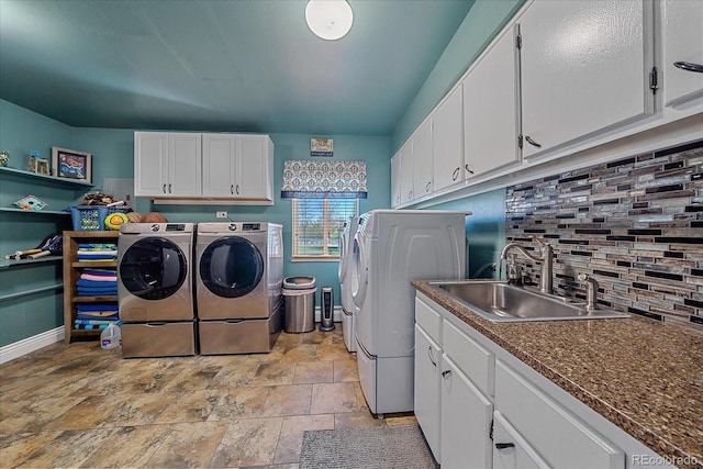 laundry area with cabinets, sink, separate washer and dryer, and light tile flooring