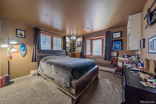 bedroom with multiple windows, carpet, and baseboard heating