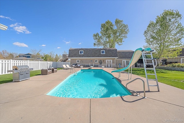 view of pool featuring a water slide, a lawn, a playground, and a patio