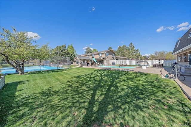 view of yard with a fenced in pool and a patio