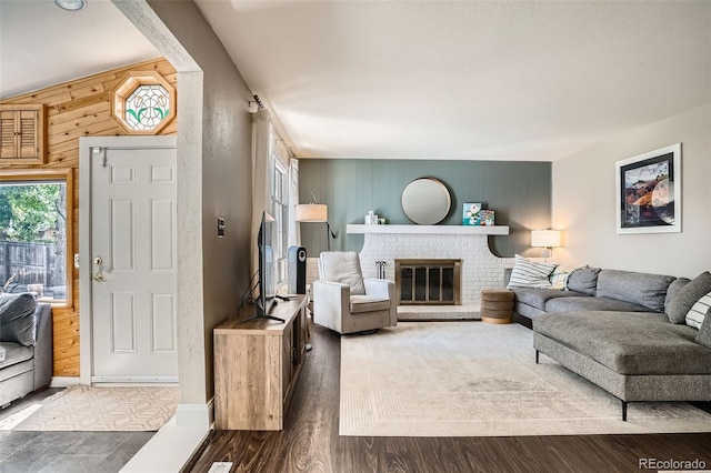 6494 W 85th Ave, Arvada, CO 80003 - living area with healthy amount of natural light, a fireplace, wood walls, and an accent wall