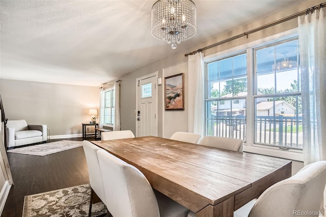 6494 W 85th Ave, Arvada, CO 80003 - dining space featuring dark wood-style flooring, a chandelier, and plenty of natural light