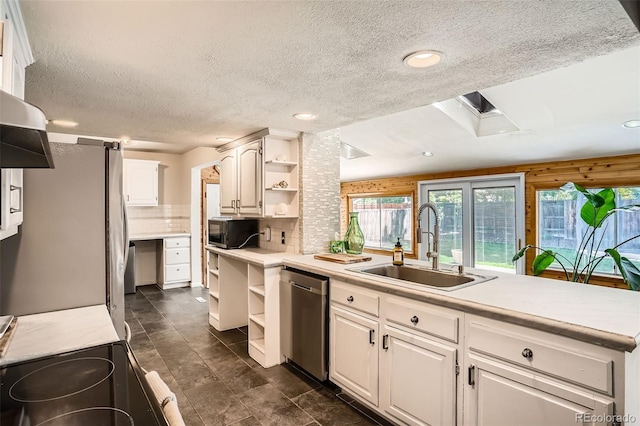 6494 W 85th Ave, Arvada, CO 80003 - kitchen with open shelves, stainless steel appliances, a textured ceiling, light countertops, and white cabinetry