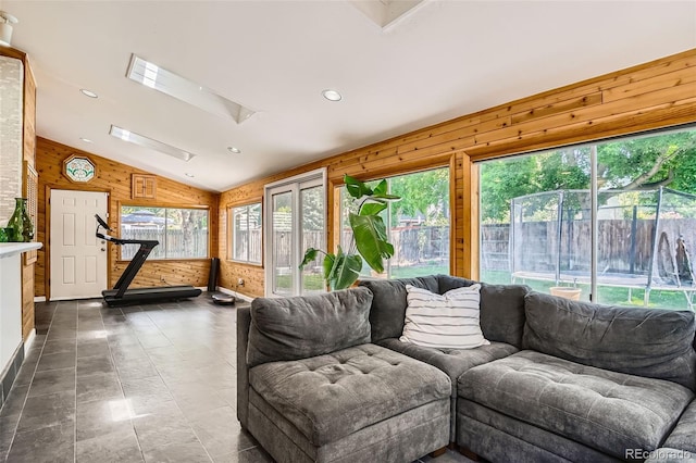 6494 W 85th Ave, Arvada, CO 80003 - living room with wooden walls, vaulted ceiling, a skylight, and recessed lighting