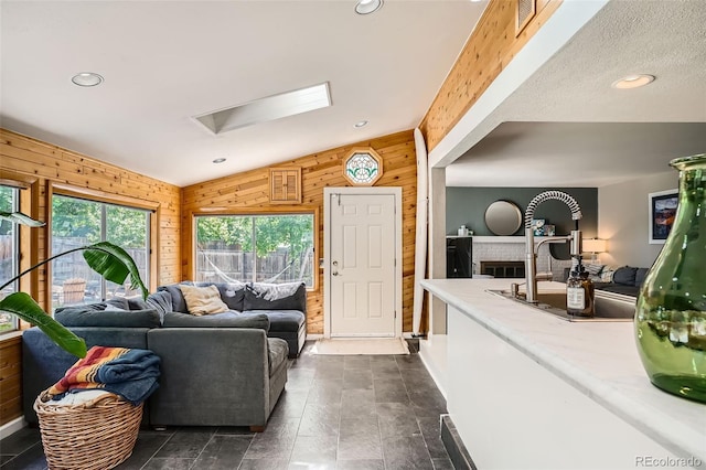 6494 W 85th Ave, Arvada, CO 80003 - living area featuring wooden walls, recessed lighting, and a skylight