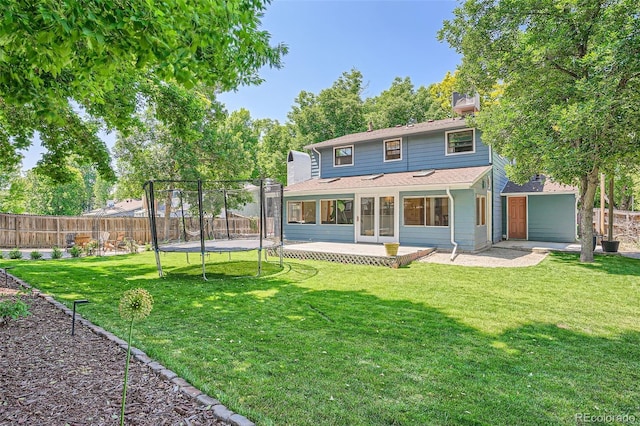 6494 W 85th Ave, Arvada, CO 80003 - back of property featuring a trampoline, a fenced backyard, and roof with shingles