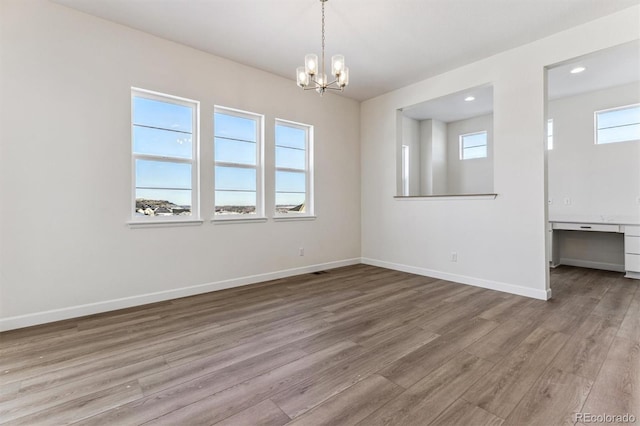 spare room featuring hardwood / wood-style floors and a wealth of natural light