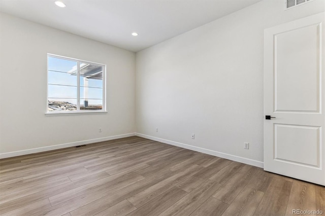 spare room with light hardwood / wood-style flooring