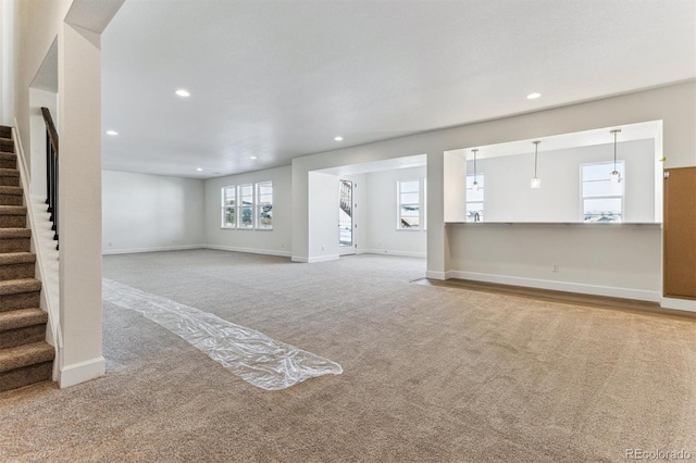 unfurnished living room featuring carpet