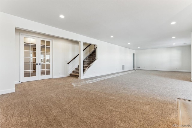 basement featuring french doors and carpet flooring