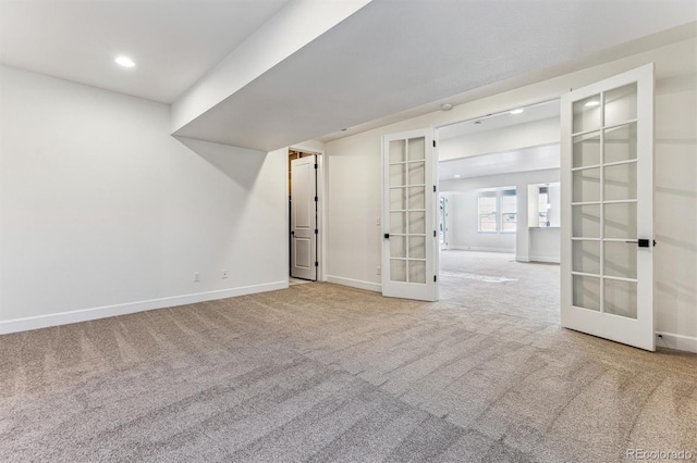 carpeted spare room with french doors