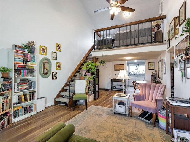 living room featuring ceiling fan, high vaulted ceiling, and hardwood / wood-style floors