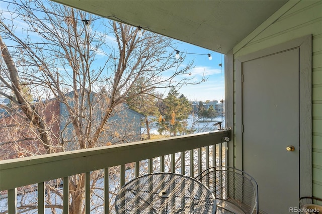 view of snow covered back of property