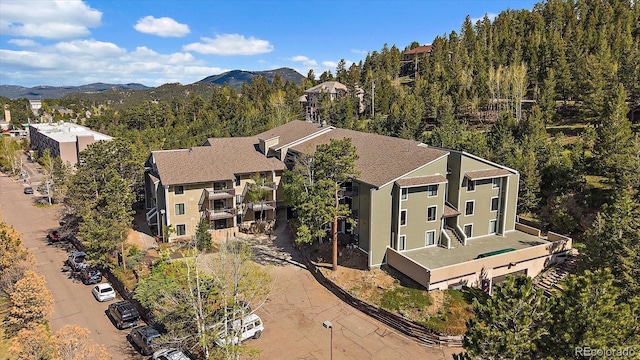 31270 John Wallace Rd Unit 310, Evergreen, CO 80439 - drone / aerial view of a mountain backdrop and a forest