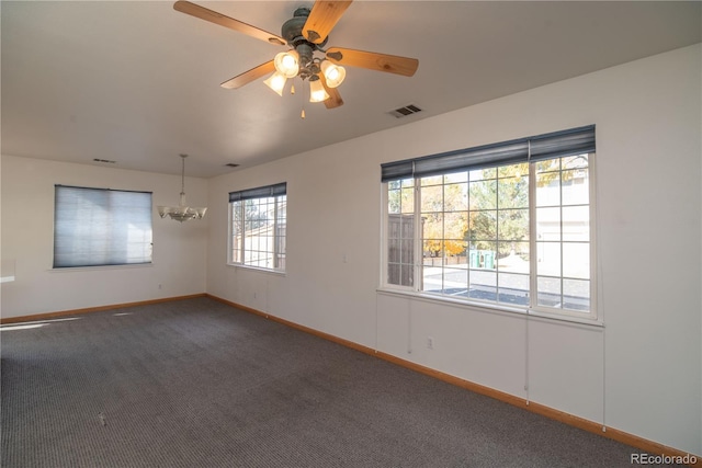 carpeted empty room with ceiling fan with notable chandelier