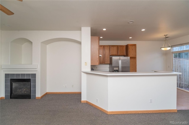 kitchen with stainless steel refrigerator with ice dispenser, carpet flooring, and pendant lighting